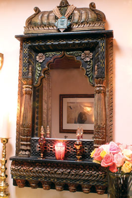 
Gilda found this hand-carved wood mirror frame at a flea market. The cabinet is a Moroccan grain cabinet that was converted into a sink cabinet, the countertop and sink are both made from Mexican Talavera tiles, and the light fixtures are miniature crystal chandeliers.
